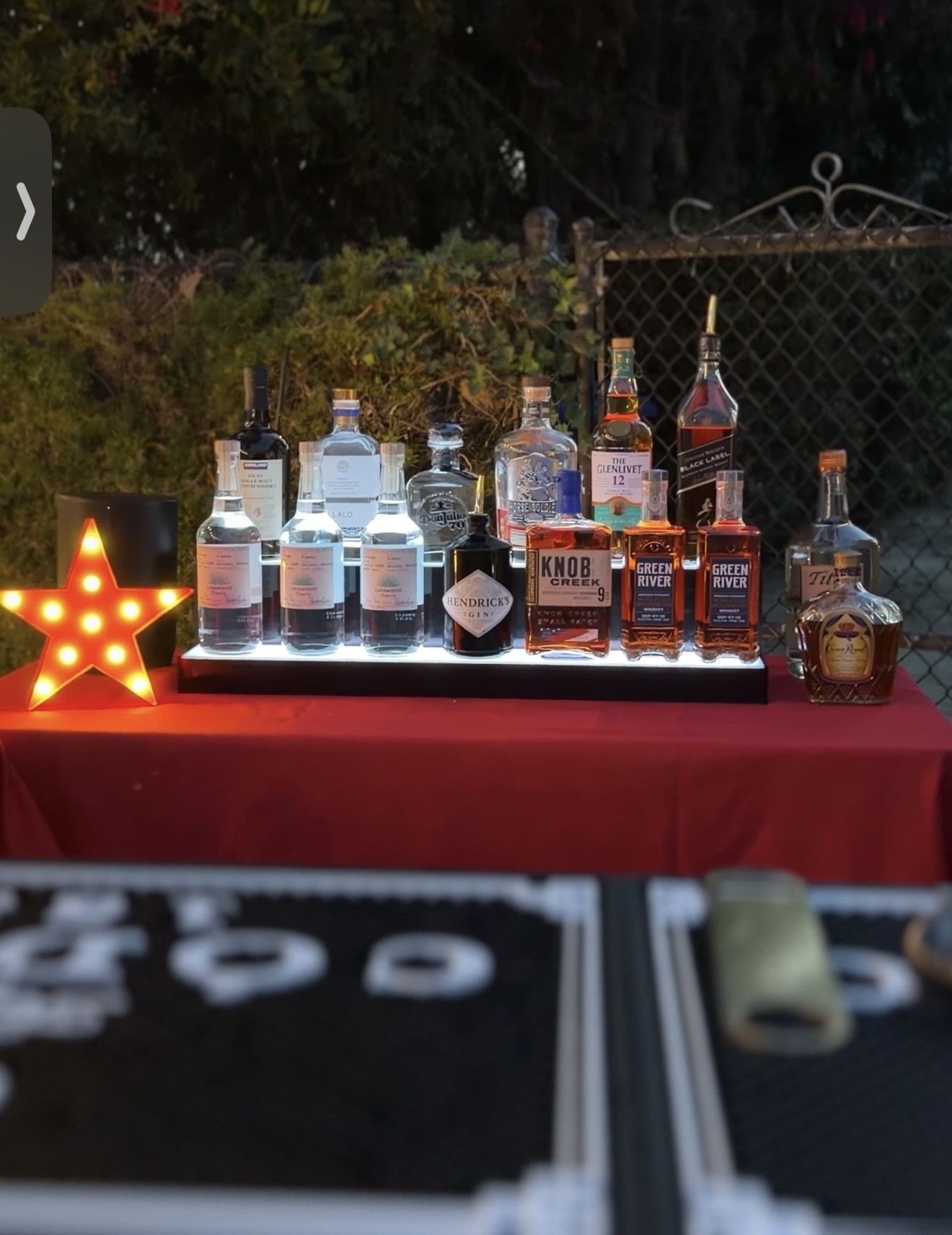 Belle crafting cocktails behind the mobile bar